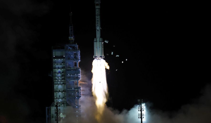 The crewed spaceship Shenzhou-13, atop a Long March-2F carrier rocket, is launched from the Jiuquan Satellite Launch Center in northwest China&#x27;s Gobi Desert, Oct. 16, 2021 (Chinatopix Via AP)