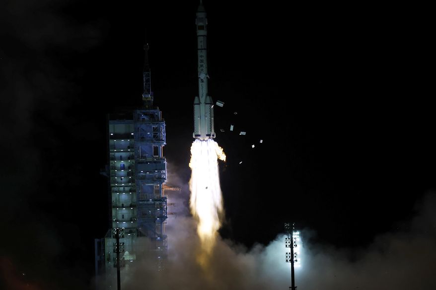The crewed spaceship Shenzhou-13, atop a Long March-2F carrier rocket, is launched from the Jiuquan Satellite Launch Center in northwest China&#39;s Gobi Desert, Oct. 16, 2021 (Chinatopix Via AP)