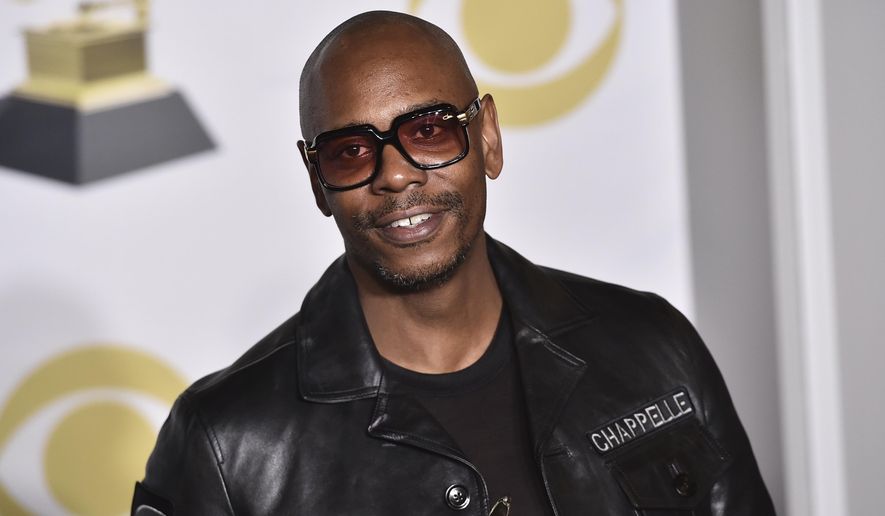 In this Jan. 28, 2018, file photo, Dave Chappelle poses in the press room with the best comedy album award for &amp;quot;The Age of Spin&amp;quot; and &amp;quot;Deep in the Heart of Texas&amp;quot; at the 60th annual Grammy Awards in New York. Netflix said Friday, Oct. 15, 2021, that it had fired an employee for disclosing confidential financial information about what it paid for Dave Chappelle’s comedy special “The Closer,&amp;quot; which some condemned as being transphobic. (Photo by Charles Sykes/Invision/AP, File)