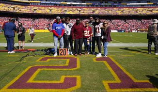 Members of the late Sean Taylor&#39;s family gather on the field as the Washington Football Team retire his number during a ceremony before the start of an NFL football game against the Kansas City Chiefs, Sunday, Oct. 17, 2021, in Landover, Md. Sean Taylor is only the third player in franchise history to receive such an honor.(AP Photo/Patrick Semansky)