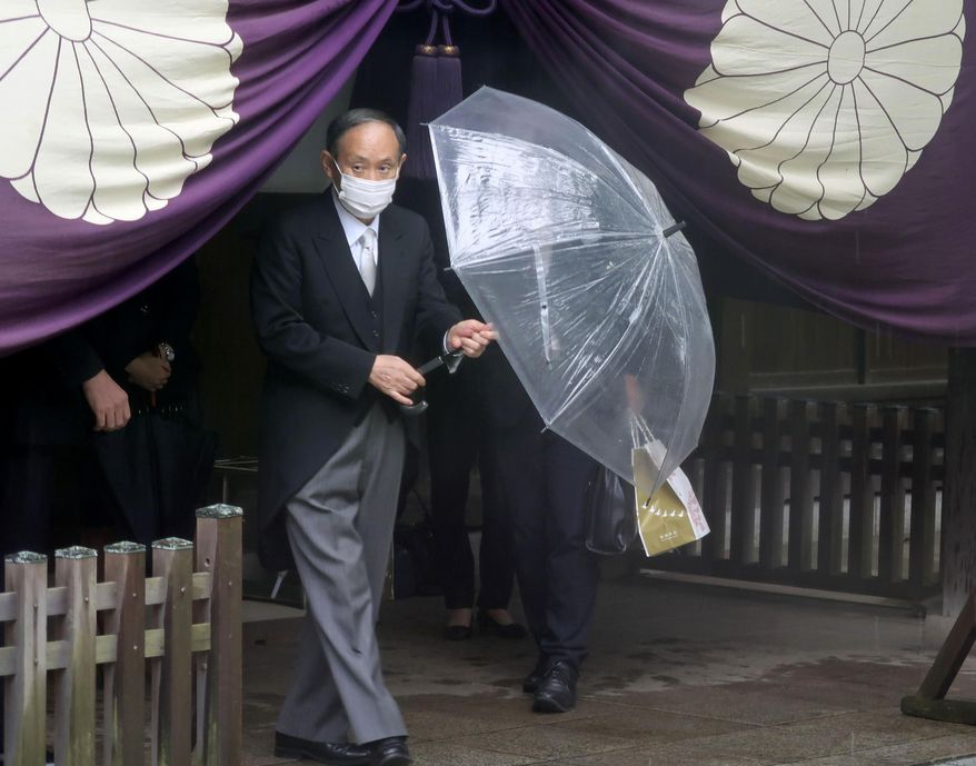 Former Japanese Prime Minister Yoshihide Suga leaves the Yasukuni Shrine in Tokyo Sunday, Oct. 17, 2021. Suga who stepped down at the end of September, prayed at the shrine during the shrine&#39;s autumn festival. The shrine is viewed by China and the Koreas as a symbol of Japanese wartime aggression. (Kyodo News via AP)