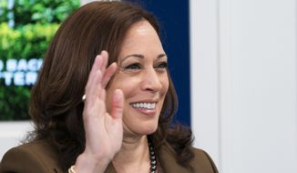 Vice President Kamala Harris waves at the end of a discussion of different care policies ranging from at-home medical care to childcare, during a virtual town hall, Thursday, Oct. 14, 2021, in the South Court Auditorium on the White House complex in Washington. (AP Photo/Jacquelyn Martin)