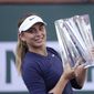 Paula Badosa, of Spain, holds up her trophy after defeating Victoria Azarenka, of Belarus, in the singles final at the BNP Paribas Open tennis tournament Sunday, Oct. 17, 2021, in Indian Wells, Calif. (AP Photo/Mark J. Terrill)