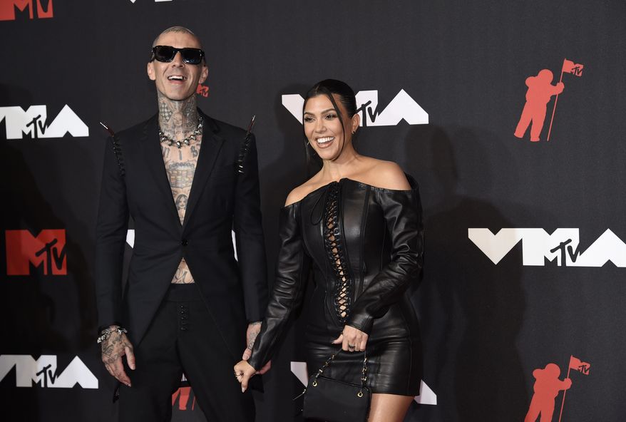 Travis Barker, left, and Kourtney Kardashian arrive at the MTV Video Music Awards at Barclays Center on Sunday, Sept. 12, 2021, in New York. A representative for the reality star and businesswoman confirmed Sunday, Oct. 17 that the couple are engaged. (Photo by Evan Agostini/Invision/AP, File)