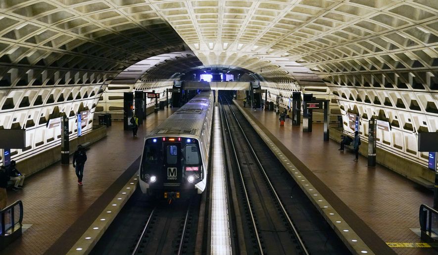 In this April 23, 2021, photo, a train arrives at Metro Center station in Washington.  Washington’s regional Metro system abruptly pulled more than half its fleet of trains from service early Monday morning over a lingering problem with the wheels and axles that caused a dramatic derailing last week. (AP Photo/Patrick Semansky) **FILE**