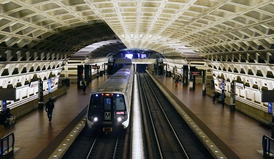 In this April 23, 2021, file photo, a train arrives at Metro Center station in Washington. (AP Photo/Patrick Semansky) ** FILE **