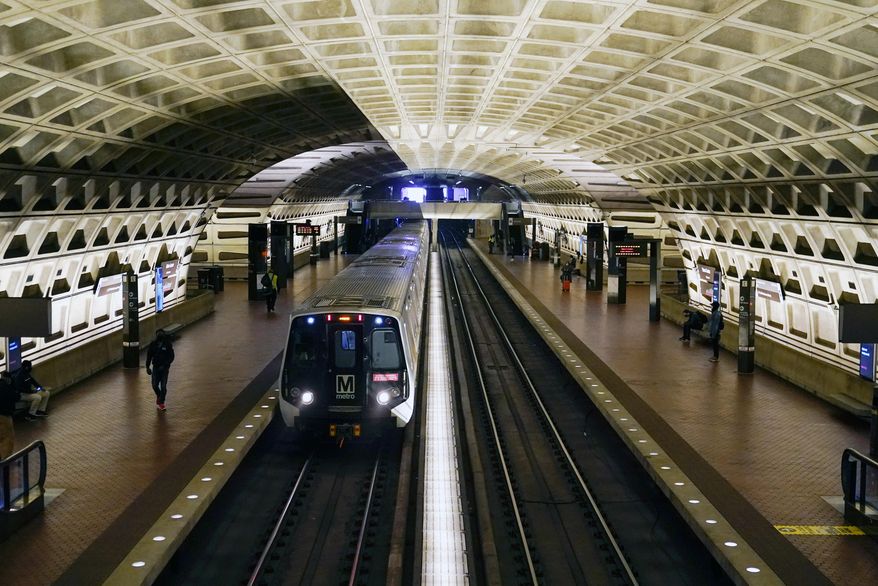 In this April 23, 2021, photo, a train arrives at Metro Center station in Washington.  Washington’s regional Metro system abruptly pulled more than half its fleet of trains from service early Monday morning over a lingering problem with the wheels and axles that caused a dramatic derailing last week. (AP Photo/Patrick Semansky) **FILE**