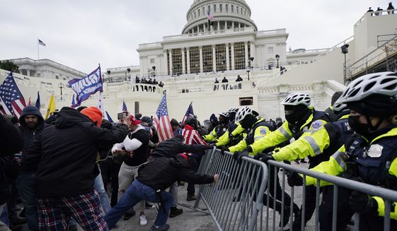 In this Jan. 6, 2021, file photo, Trump supporters try to break through a police barrier at the U.S. Capitol in Washington. A House committee tasked with investigating the Jan. 6 Capitol insurrection is moving swiftly to hold at least one of Donald Trumps allies, former White House aide Steve Bannon, in contempt. That&#39;s happening as the former president is pushing back on the probe in a new lawsuit. (AP Photo/Julio Cortez)