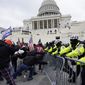 In this Jan. 6, 2021, file photo, Trump supporters try to break through a police barrier at the U.S. Capitol in Washington. A House committee tasked with investigating the Jan. 6 Capitol insurrection is moving swiftly to hold at least one of Donald Trumps allies, former White House aide Steve Bannon, in contempt. That&#x27;s happening as the former president is pushing back on the probe in a new lawsuit. (AP Photo/Julio Cortez)