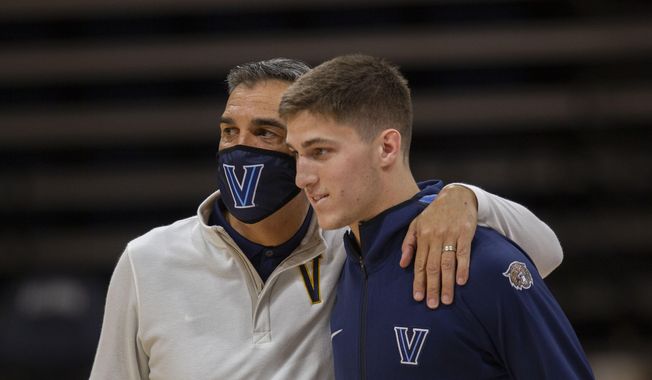 Villanova head coach Jay Wright, left, and guard Collin Gillespie are shown before an NCAA college basketball game against Creighton in Villanova, Pa., in this Wednesday, March 3, 2021, file photo. Villanova has dominated the Big East over the last decade under the guidance of coach Jay Wright. The fourth-ranked Wildcats were the unanimous choice to win the conference in a preseason coaches poll released Tuesday, Oct. 19, 2021. Villanova is led by guard Collin Gillespie, who was the coaches&#x27; pick for preseason player of the year.  (AP Photo/Laurence Kesterson, File) **FILE**