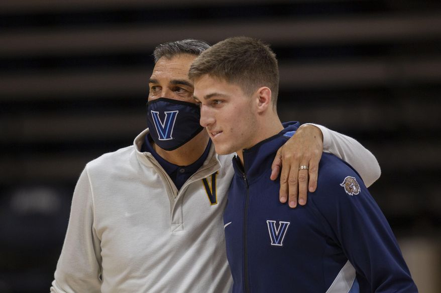 Villanova head coach Jay Wright, left, and guard Collin Gillespie are shown before an NCAA college basketball game against Creighton in Villanova, Pa., in this Wednesday, March 3, 2021, file photo. Villanova has dominated the Big East over the last decade under the guidance of coach Jay Wright. The fourth-ranked Wildcats were the unanimous choice to win the conference in a preseason coaches poll released Tuesday, Oct. 19, 2021. Villanova is led by guard Collin Gillespie, who was the coaches&#39; pick for preseason player of the year.  (AP Photo/Laurence Kesterson, File) **FILE**