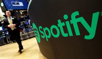 In this Tuesday, April 3, 2018 file photo, a trading post sports the Spotify logo on the floor of the New York Stock Exchange. U.K. regulators are stepping up scrutiny of the country&#39;s music streaming market to see whether there&#39;s enough competition, after lawmakers outlined concerns that big online major platforms like Spotify may be too dominant. The U.K.&#39;s competition watchdog said Tuesday, Oct. 19 2021 it will carry out a “market study” to assess whether fresh measures are needed to improve streaming competition.  (AP Photo/Richard Drew, File)FILE