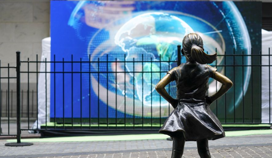 The Fearless Girl statue is seen in front of a video screen displaying the image of the earth outside the New York Stock Exchange, Tuesday, Oct. 5, 2021, in New York. Stocks are moving modestly higher on Wall Street in early trading Tuesday, Oct. 19, 2021 as corporate earnings reporting gets into full swing. The benchmark S&amp;amp;P 500 was up 0.3% in the first few minutes of trading, and the Dow Jones Industrial Average was up 0.2%. Health care companies were making some of the biggest gains in the early going. (AP Photo/Mary Altaffer, file)