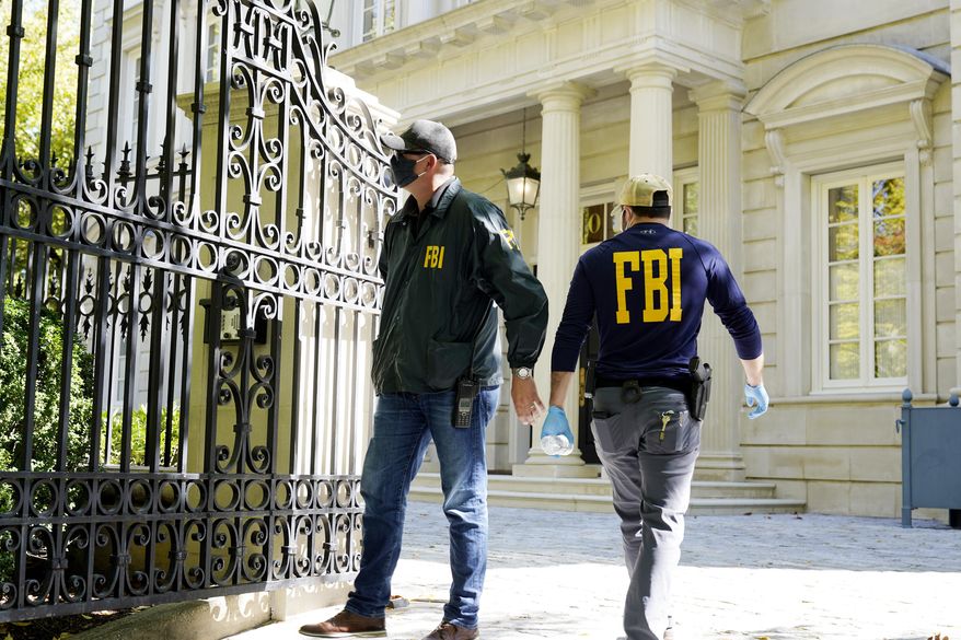 Federal agents stand in front of a home of Russian oligarch Oleg Deripaska, Tuesday, Oct. 19, 2021, in Washington. An agency spokesperson says FBI agents were at a home in Washington connected to Deripaska to carry out &quot;court-authorized law enforcement activity.&quot; (AP Photo/Manuel Balce Ceneta) **FILE**