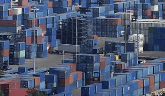 A trailer truck drives amid stacked containers at Port Miami, Wednesday, Oct. 20, 2021, in Miami. The Federal Reserve reports that the economy faced a number of headwinds at the start of this month, ranging from supply-chain disruptions and labor shortages to uncertainty about the delta variant of COVID-19. (AP Photo/Rebecca Blackwell)