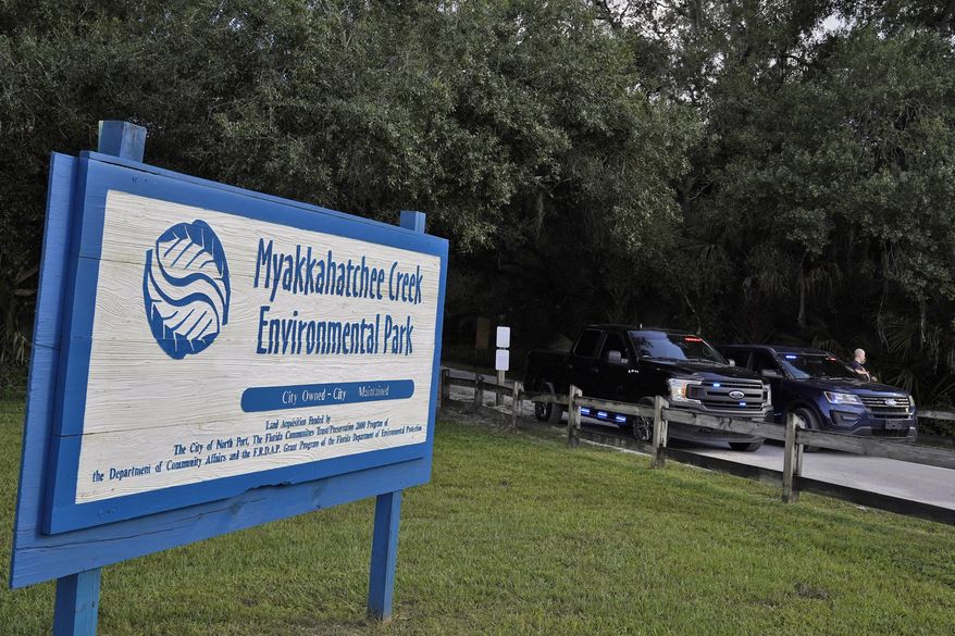 North Port, Fla., police officer block the entrance to the Myakkahatchee Creek Environmental Park Wednesday, Oct. 20, 2021, in North Port, Fla. Items believed to belong to Brian Laundrie and potential human remains were found in a Florida wilderness park during a search for clues in the slaying of Gabby Petito . (AP Photo/Chris O&#39;Meara)