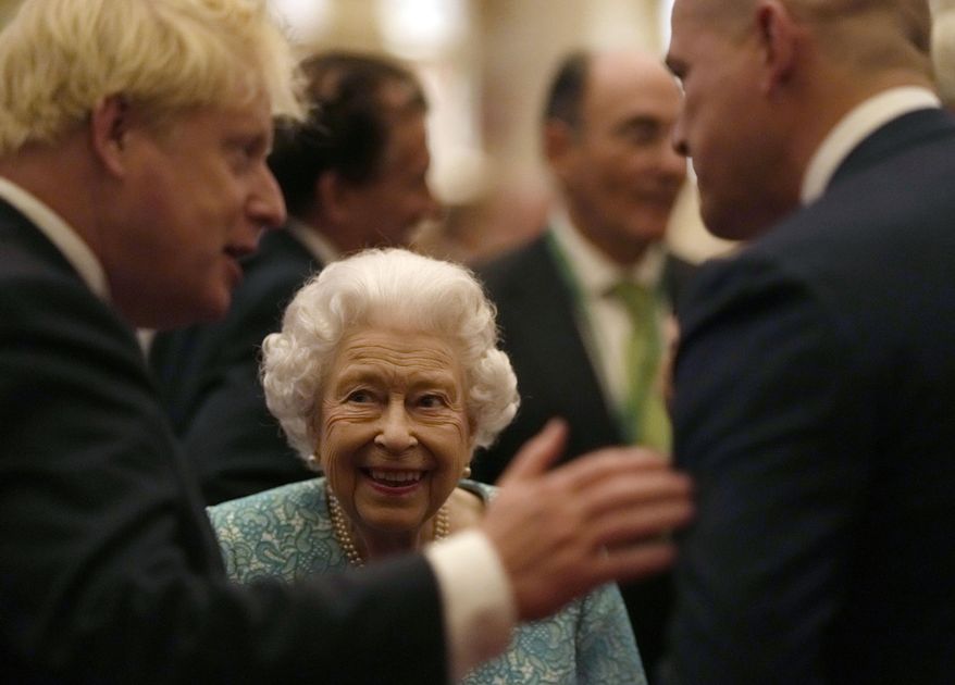 Britain&#39;s Queen Elizabeth II and Prime Minister Boris Johnson, left, greet guests at a reception for the Global Investment Summit in Windsor Castle, Windsor, England, Tuesday, Oct. 19, 2021. (AP Photo/Alastair Grant, Pool)