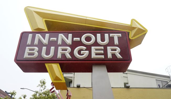 The sign to an In-N-Out restaurant is shown in San Francisco&#x27;s Fisherman&#x27;s Wharf, Wednesday, Oct. 20, 2021. The In-N-Out hamburger chain is sizzling mad after San Francisco shut down its indoor dining for refusing to check customers&#x27; vaccination status. The company&#x27;s Fisherman&#x27;s Wharf location, its only one in San Francisco, was temporarily shut by the Department of Public Health on Oct. 14. (AP Photo/Jeff Chiu)