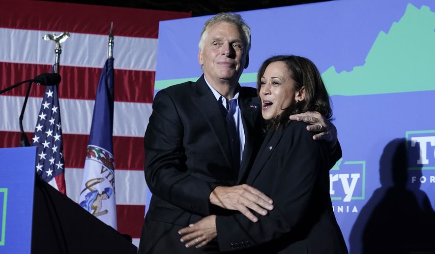 Vice President Kamala Harris, right, shares a hug with Democratic gubernatorial candidate, former Virginia Gov. Terry McAuliffe during a rally in Dumfries, Va., Thursday, Oct. 21, 2021. McAuliffe will face Republican Glenn Youngkin in the November election. (AP Photo/Steve Helber)