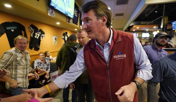 Virginia Republican gubernatorial candidate Glenn Youngkin greets supporters during a meet and greet at a sports bar in Chesapeake, Va., Monday, Oct. 11, 2021. Youngkin faces former Governor Terry McAuliffe in the November election. (AP Photo/Steve Helber)