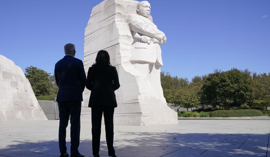 President Joe Biden and Vice President Kamala Harris stand together at the Martin Luther King, Jr. Memorial as they arrive to attend an event marking the 10th anniversary of the dedication of memorial in Washington, Thursday, Oct. 21, 2021. (AP Photo/Susan Walsh)
