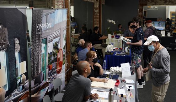 In this Sept. 22, 2021, file photo, prospective employers and job seekers interact during a job fair in the West Hollywood section of Los Angeles. (AP Photo/Marcio Jose Sanchez) ** FILE **