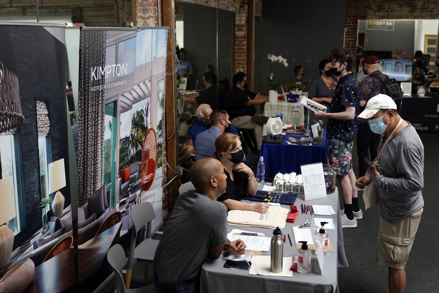In this Sept. 22, 2021, file photo, prospective employers and job seekers interact during a job fair in the West Hollywood section of Los Angeles. (AP Photo/Marcio Jose Sanchez) ** FILE **