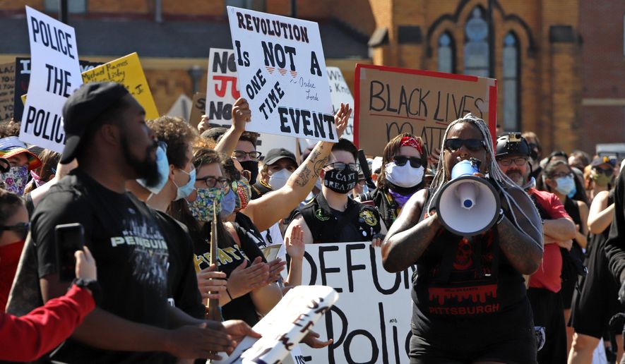 In this June 7, 2020, file photo, protesters participate in a Black Lives Matter rally on Mount Washington overlooking downtown Pittsburgh to protest the death of George Floyd, who died after being restrained by Minneapolis police officers on May 25, 2020.  (AP Photo/Gene J. Puskar, File)