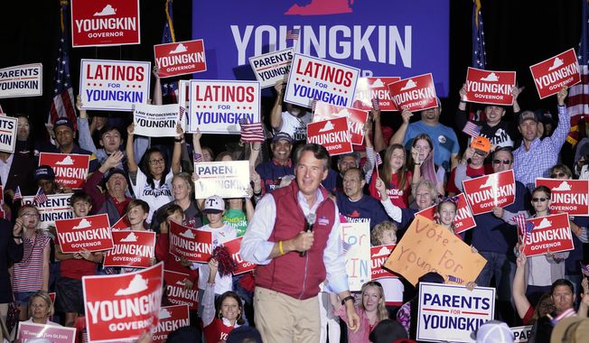 Republican gubernatorial candidate Glenn Youngkin reacts to the crowd during a rally in Glen Allen, Va., Saturday, Oct. 23, 2021. Youngkin will face Democrat Terry McAuliffe in the November election. (AP Photo/Steve Helber)