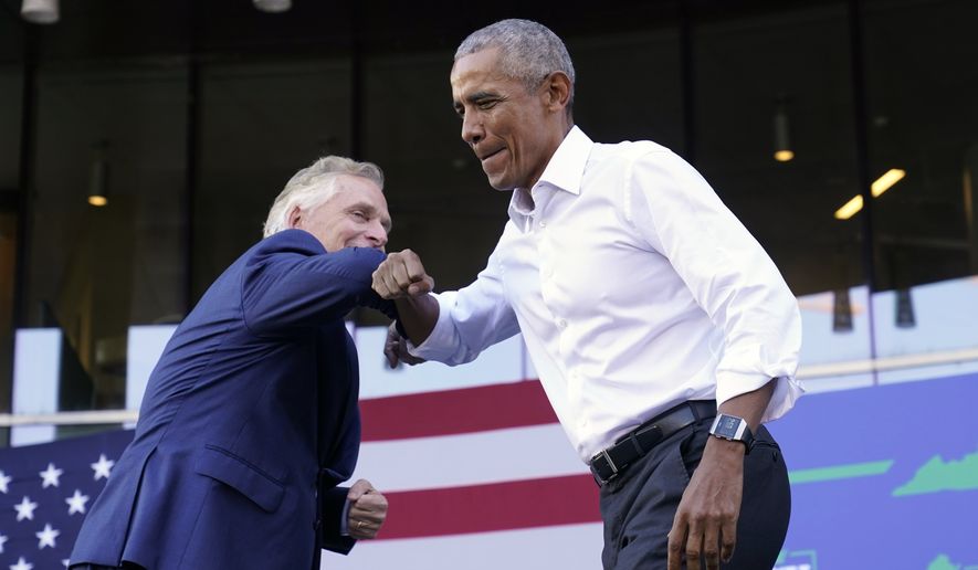 Former President Barack Obama, right, gives an elbow bump to Democratic gubernatorial candidate, former Virginia Gov. Terry McAuliffe during a rally in Richmond, Va., Saturday, Oct. 23, 2021. McAuliffe will face Republican Glenn Youngkin in the November election. (AP Photo/Steve Helber)
