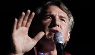 Republican gubernatorial candidate Glenn Youngkin gestures during a rally in Glen Allen, Va., Saturday, Oct. 23, 2021. Youngkin will face Democrat Terry McAuliffe in the November election. (AP Photo/Steve Helber)