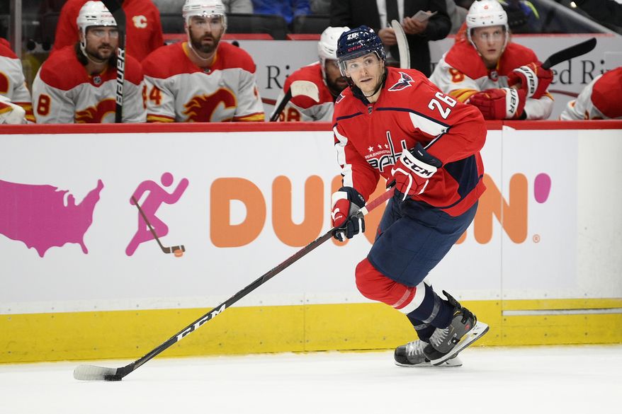 Washington Capitals center Nic Dowd (26) skates with the puck during the first period of an NHL hockey game against the Calgary Flames, Saturday, Oct. 23, 2021, in Washington. (AP Photo/Nick Wass)
