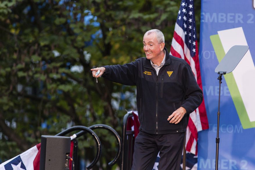 Gov. Phil Murphy points to the crowd at an early vote rally at Weequahic Park, Saturday, Oct. 23, 2021, in Newark, N.J. (AP Photo/Stefan Jeremiah)