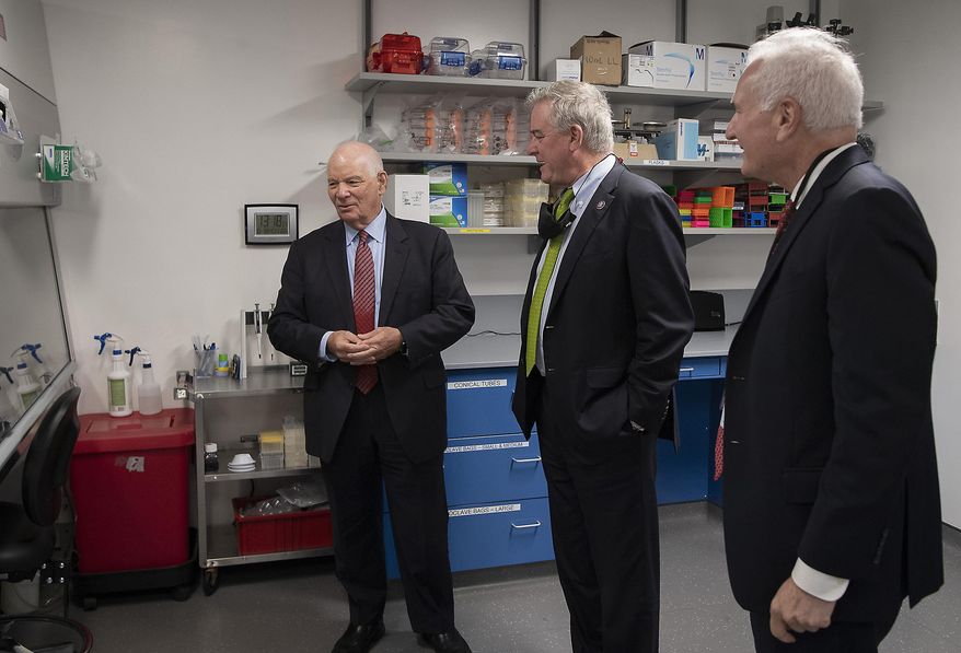 U.S. Sen. Ben Cardin, D-Md, left, U.S. Rep. David Trone, D-6th-Md., center, and Seth Lederman, Tonic CEO, chat in a lab area of the Tonix Pharmaceuticals facility following a ribbon-cutting ceremony, Monday, Oct. 18, 2021 in Frederick, Md. With the snip of a ribbon on a windy Monday afternoon, Tonix Pharmaceuticals officially has a research and development center for infectious diseases — and it’s located in Frederick, right down the road from the city’s municipal airport. (Bill Green/The Frederick News-Post via AP) ** FILE **