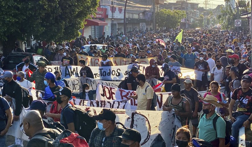 A caravan of migrants, most from central America, head north as they depart from Tapachula, Mexico, Saturday, Oct. 23, 2021. Immigration activists say they will lead migrants out of the southern Mexico city of Tapachula Saturday at the start of a march they hope will bring them to Mexico City to press their case for better treatment. (AP Photo/ Edgar H. Clemente)