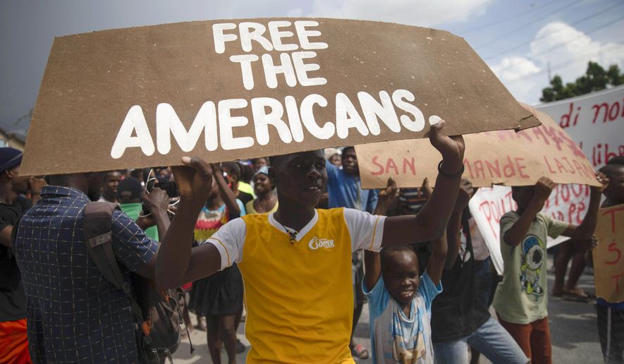 Protesters demand the release of kidnapped missionaries near the missionaries&#x27; headquarters in Titanyen, north of Port-au-Prince, Haiti, Tuesday, Oct. 19, 2021. A group of 17 U.S. missionaries including children was kidnapped by a gang in Haiti on Saturday, Oct. 16, according to a voice message sent to various religious missions by an organization with direct knowledge of the incident. (AP Photo/Joseph Odelyn)