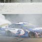Kyle Larson (5) does a burnout after winning a NASCAR Cup Series auto race at Kansas Speedway in Kansas City, Kan., Sunday, Oct. 24, 2021. (AP Photo/Colin E. Braley)