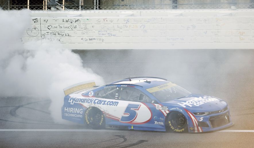 Kyle Larson (5) does a burnout after winning a NASCAR Cup Series auto race at Kansas Speedway in Kansas City, Kan., Sunday, Oct. 24, 2021. (AP Photo/Colin E. Braley)