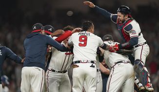Atlanta Braves celebrate after winning Game 6 of baseball&#39;s National League Championship Series against the Los Angeles Dodgers Sunday, Oct. 24, 2021, in Atlanta. The Braves defeated the Dodgers 4-2 to win the series. (AP Photo/Brynn Anderson)