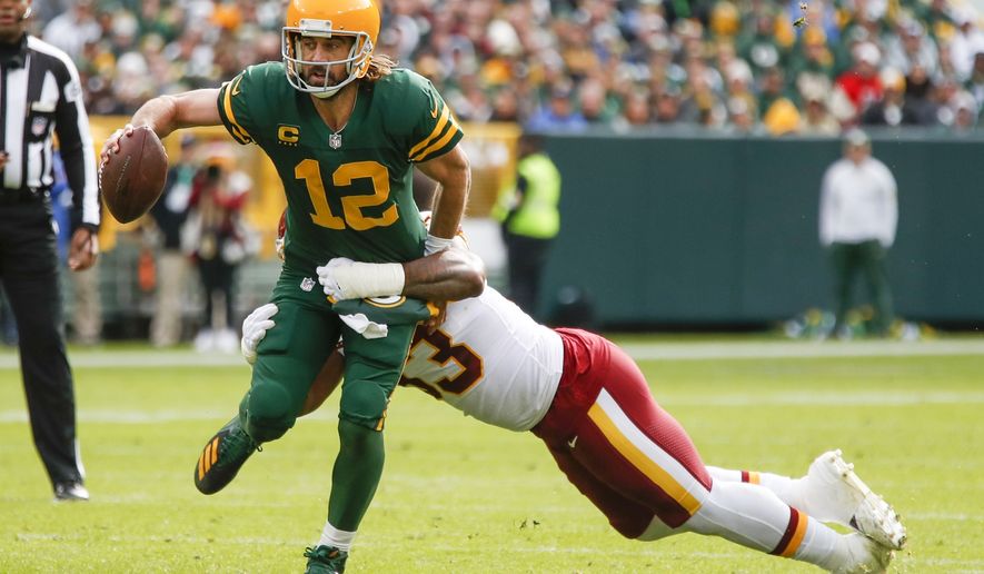 Washington Football Team&#39;s Jonathan Allen stops Green Bay Packers&#39; Aaron Rodgers during the first half of an NFL football game Sunday, Oct. 24, 2021, in Green Bay, Wis. (AP Photo/Matt Ludtke)