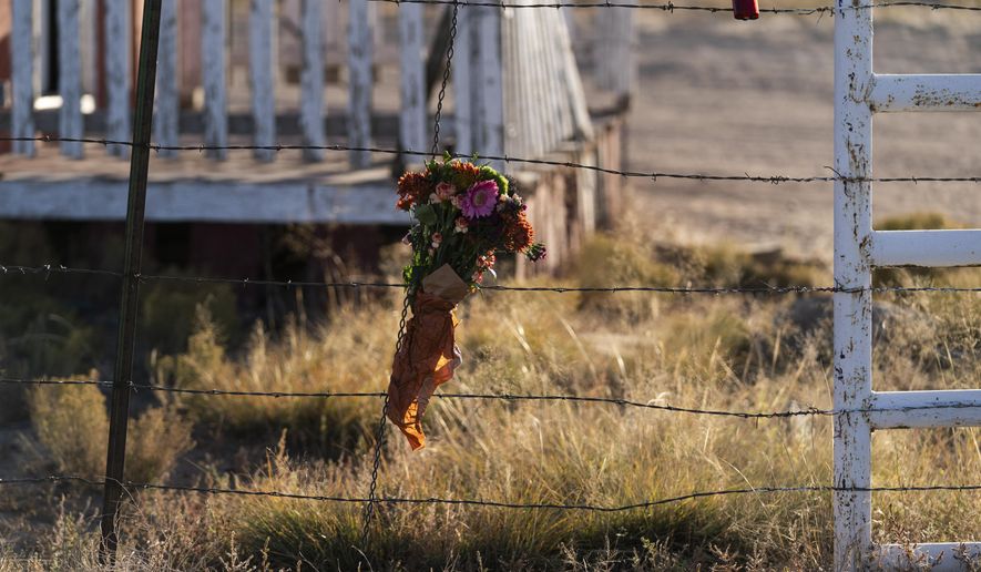 A bouquet of flowers is left to honor cinematographer Halyna Hutchins outside the Bonanza Creek Ranch in Santa Fe, N.M., Sunday, Oct. 24, 2021. Hutchins died after actor Alec Baldwin fired a fatal gunshot from a prop gun that he had been told was safe. (AP Photo/Jae C. Hong)
