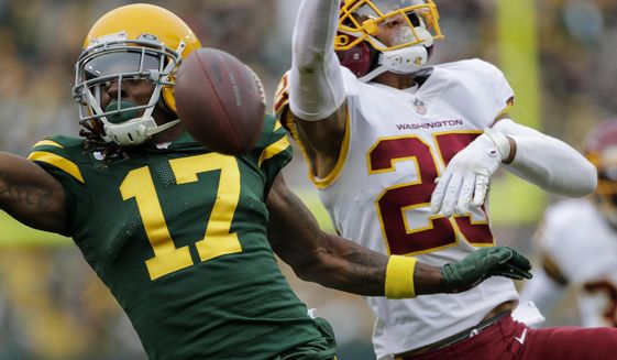 Washington Football Team&#39;s Benjamin St-Juste is called for pass interference on Green Bay Packers&#39; Davante Adams during the second half of an NFL football game Sunday, Oct. 24, 2021, in Green Bay, Wis. (AP Photo/Aaron Gash)