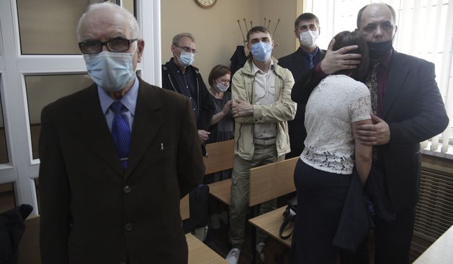 Members of the Jehovah&#x27;s Witnesses attend a court session in Perm, Russia, Wednesday, May 12, 2021. A court in the Russian city of Perm handed suspended sentences to five members of the Jehovah&#x27;s Witnesses on Wednesday in connection with their beliefs. Russia banned the Jehovah&#x27;s Witnesses in 2017 and declared it an extremist group, exposing all of its followers to prosecution. All five were handed suspended sentences between 2.5 and 7 years. (AP Photo/Anastasia Yakovleva)