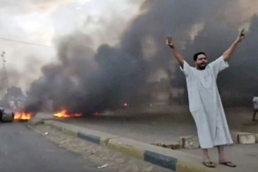 In this frame taken from video a man shouts slogans during a protest in Khartoum, Sudan, Monday, Oct. 25, 2021. Military forces arrested Sudan&#39;s acting prime minister and senior government officials Monday, disrupted internet access and blocked bridges in the capital Khartoum, the country&#39;s information ministry said, describing the actions as a coup. In response, thousands flooded the streets of Khartoum and its twin city of Omdurman to protest the apparent military takeover. Footage shared online appeared to show protesters blocking streets and setting fire to tires as security forces used tear gas to disperse them. (New Sudan NNS via AP)