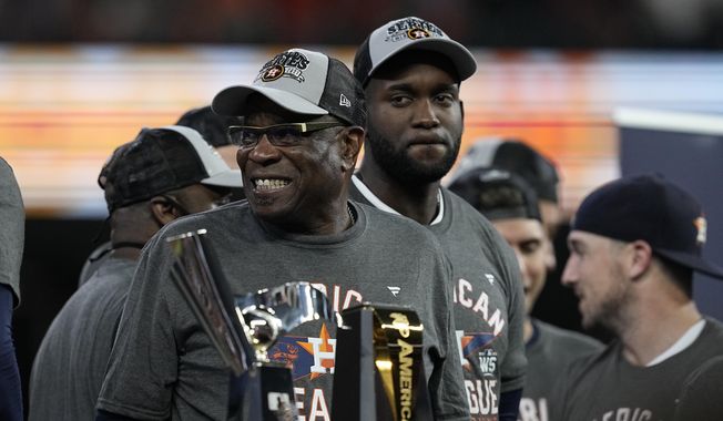 Houston Astros manager Dusty Baker Jr. stands by the trophy after their win against the Boston Red Sox in Game 6 of baseball&#x27;s American League Championship Series Friday, Oct. 22, 2021, in Houston. The Astros won 5-0, to win the ALCS series in game six.(AP Photo/Tony Gutierrez) **FILE**