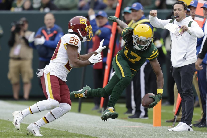 Green Bay Packers&#39; Davante Adams is pushed out of bounds by Washington Football Team&#39;s Kendall Fuller after making a catch during the second half of an NFL football game Sunday, Oct. 24, 2021, in Green Bay, Wis. (AP Photo/Matt Ludtke) **FILE**