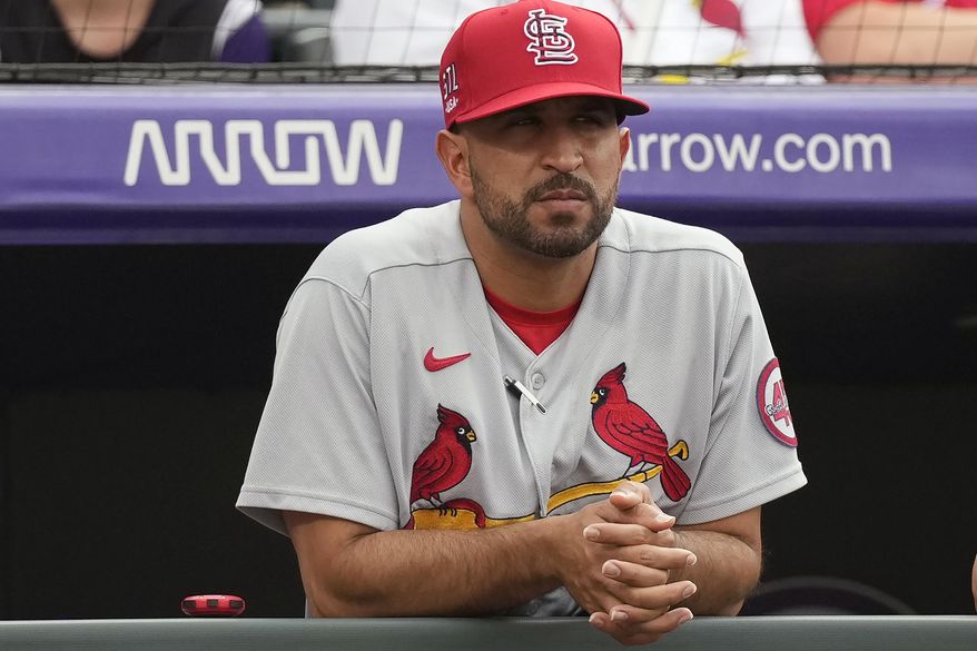 St. Louis Cardinals bench coach Oliver Marmol watches from the dugout in the first inning of the team&#39;s baseball game against the Colorado Rockies in Denver, in this Friday, July 2, 2021, file photo. The Cardinals plan to announce Monday, Oct. 25, 2021, that bench coach Oliver Marmol will be promoted to replace fired manager Mike Shildt, according to a person familiar with the decision. The person spoke to The Associated Press on condition of anonymity Sunday night because the team hadn&#39;t revealed the hiring publicy. (AP Photo/David Zalubowski, File) **FILE**