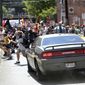 In this Aug. 12, 2017, file photo, a vehicle drives into a group of protesters demonstrating against a white nationalist rally in Charlottesville, Va. (Ryan M. Kelly/The Daily Progress via AP, File)