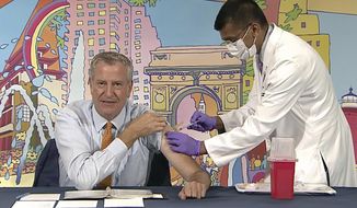 In this image from video, New York Mayor Bill de Blasio, left, receives a COVID-19 Moderna vaccine booster from New York City Health Commissioner Dr. Dave Chokshi, during the mayor&#39;s daily news briefing, Monday, Oct, 25, 2021. New York Gov. Kathy Hochul and Mayor Bill de Blasio each received COVID-19 boosters Monday as part of their efforts to promote widespread vaccinations. (Office of the New York Mayor via AP)