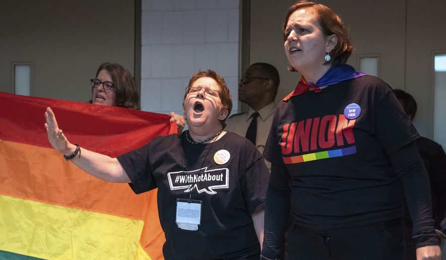 Protesters objecting to the adoption of the Traditional Plan gather and protest outside the United Methodist Church&#39;s 2019 Special Session of the General Conference in St. Louis, Mo., Tuesday, Feb. 26, 2019. America&#39;s second-largest Protestant denomination faces a likely fracture as delegates at the crucial meeting move to strengthen bans on same-sex marriage and ordination of LGBT clergy. (AP Photo/Sid Hastings) ** FILE **